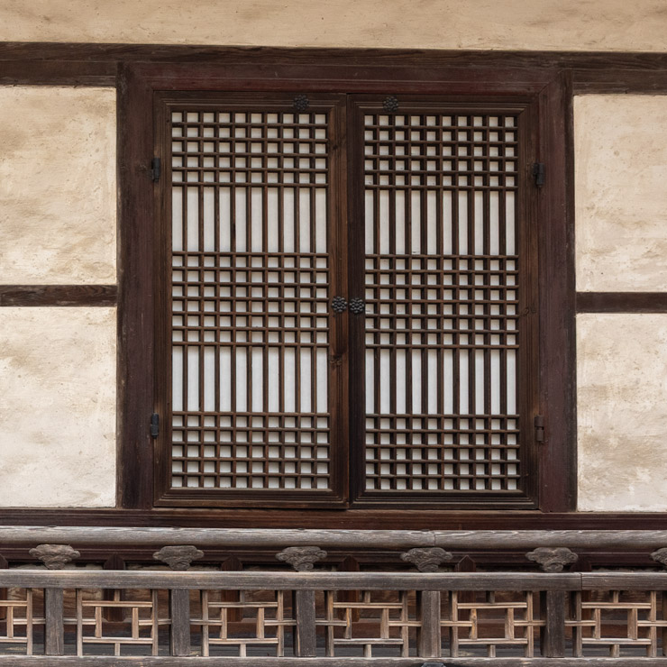 Traditional Korean lattice window at Changdeokgung Palace in Seoul, featuring a wooden frame with intricate geometric patterns and translucent hanji paper, typical of Joseon-era architecture.