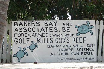 Sign says, "Bakers Bay, be forewarned when golf kills god's reef"