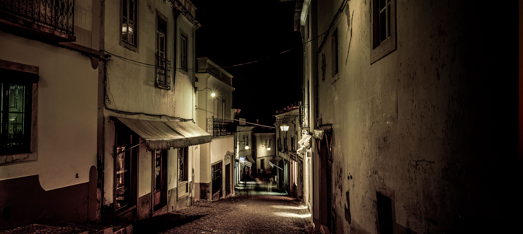 Photo of Evora, Portugal at Night.  Sloped alleyways.