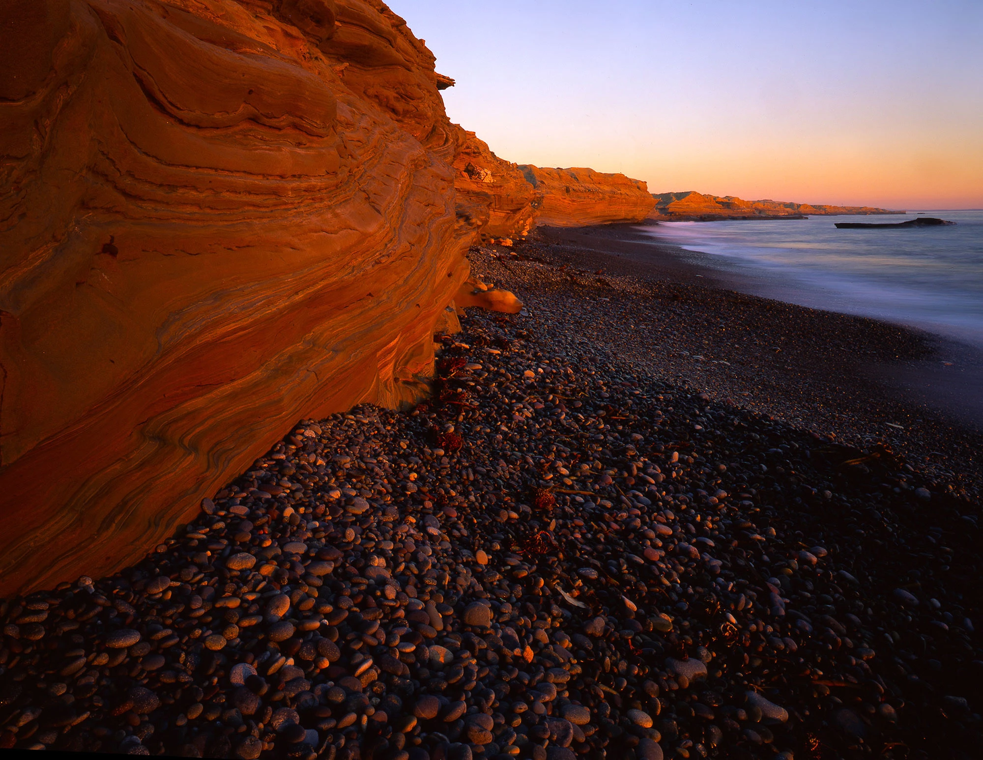 Baja California coast with rugged cliffs and blue Pacific waters meeting the desert landscape