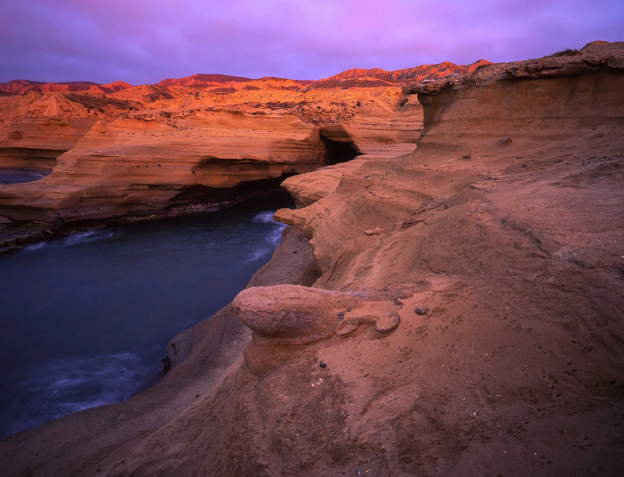 Sunset over Coyote Bay in Baja California Sur, with glowing skies reflecting on calm water