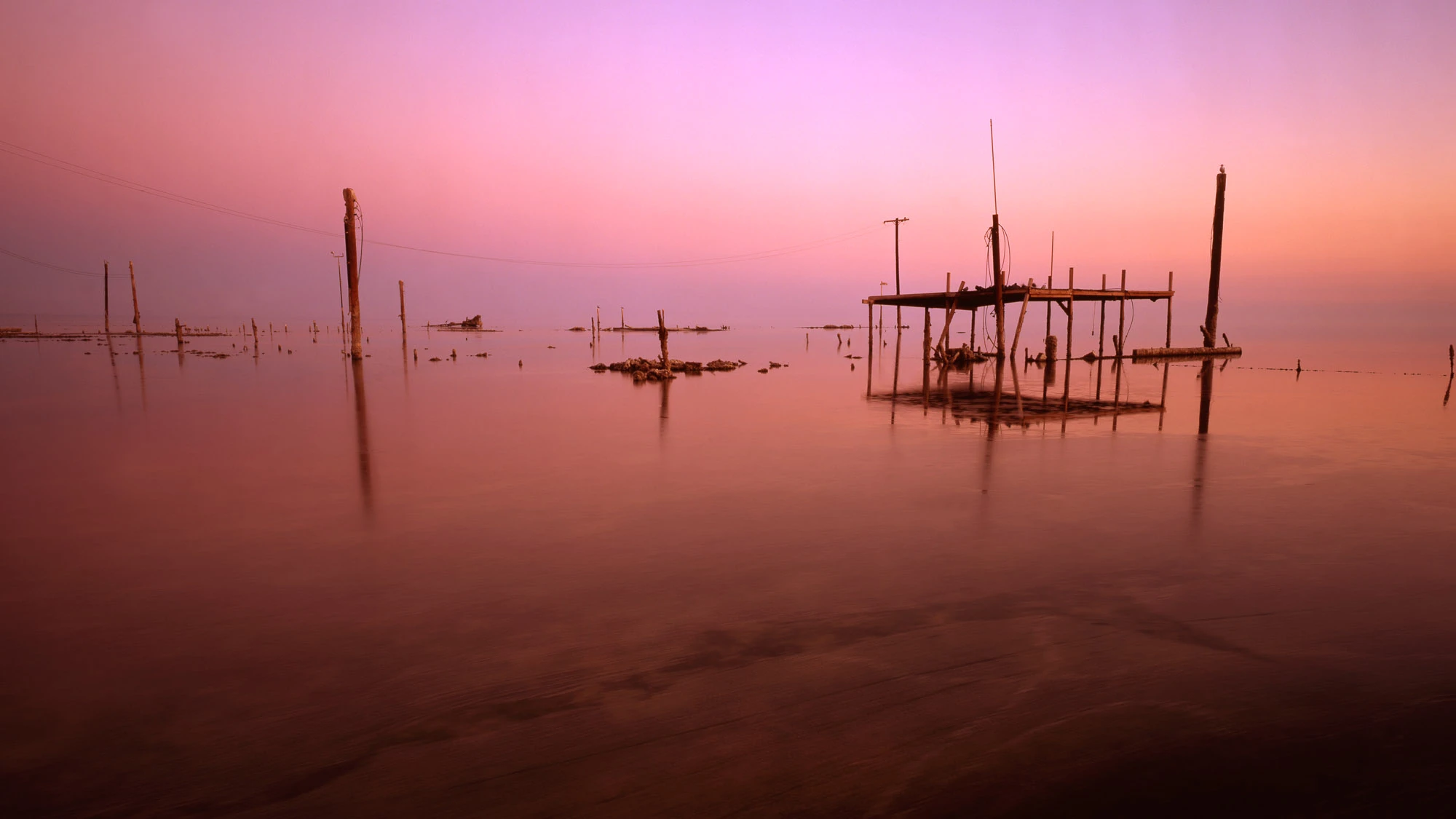 Narrow dusk alley in Rovinj, Croatia—warm stone walls, glowing windows and lantern light, polished cobbles tapering toward the sea—an invitation to wander and discover Europe.