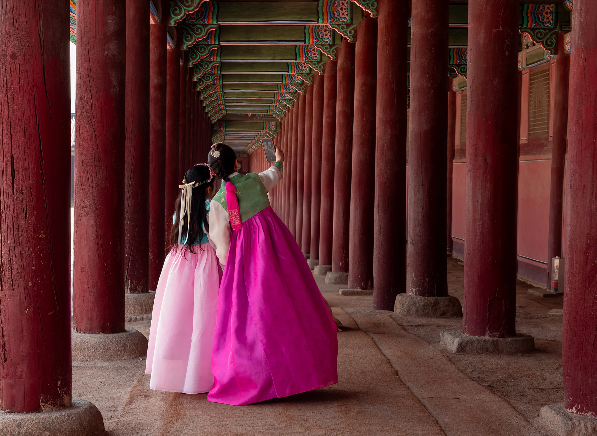 Dressed in traditional Korean hanbok, a mother and daughter take a selfie inside Gyeongbokgung Palace. Free entry is granted to visitors in hanbok, and thousands of Koreans and tourists take up the offer.
